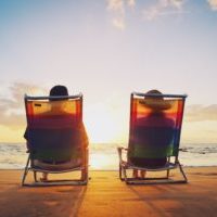 12952671 - happy romantic couple enjoying beautiful sunset at the beach